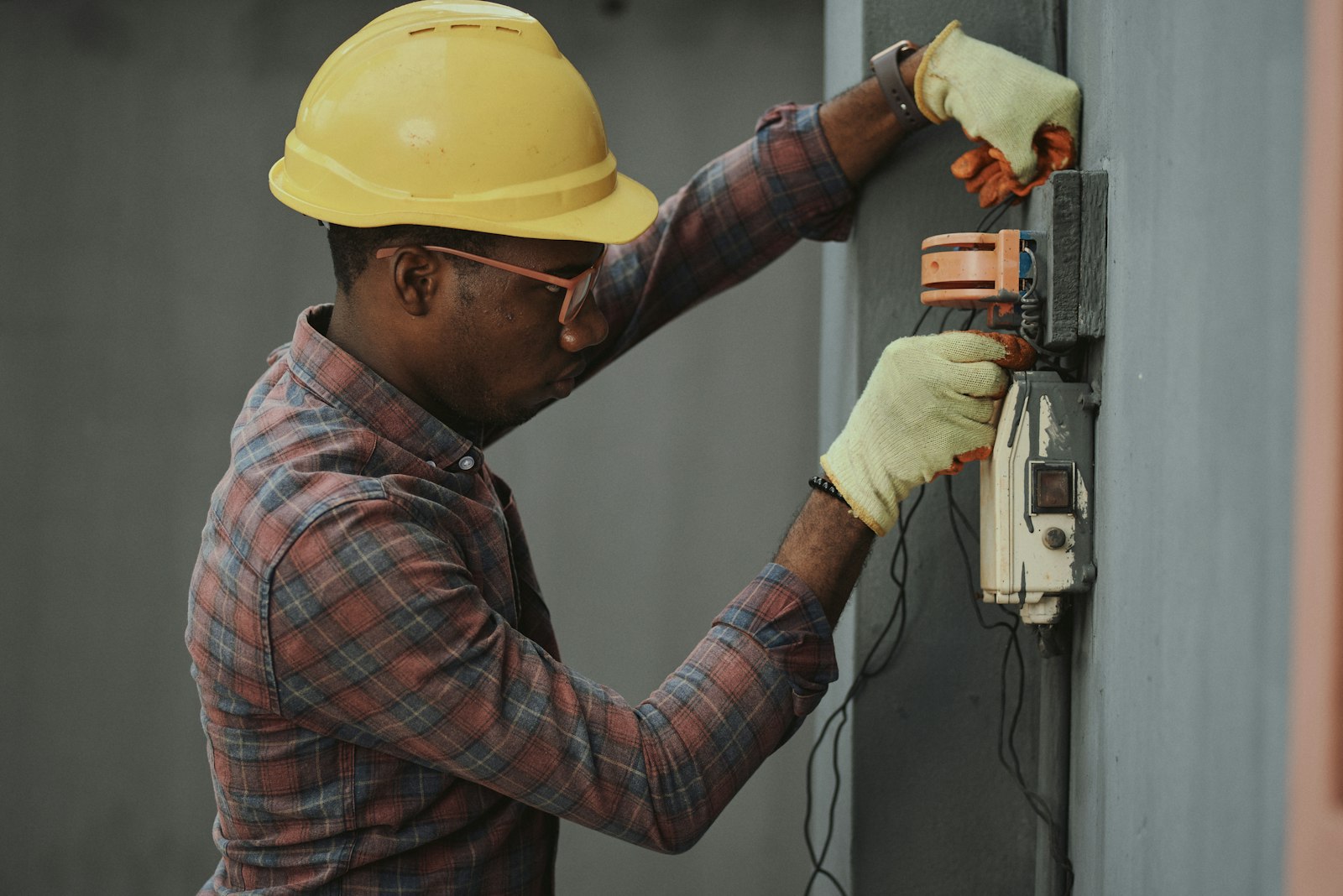 Electrician working on electrical panel